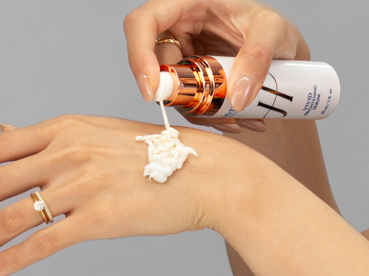 Laziza from LAZ Skincare demonstrating the texture and application of Hydrinity Vivid Brightening Serum on her hand