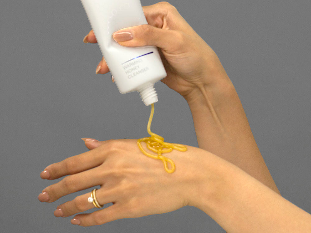 Laziza from LAZ Skincare demonstrating the texture and application of iS Clinical Warming Honey Cleanser on her hand