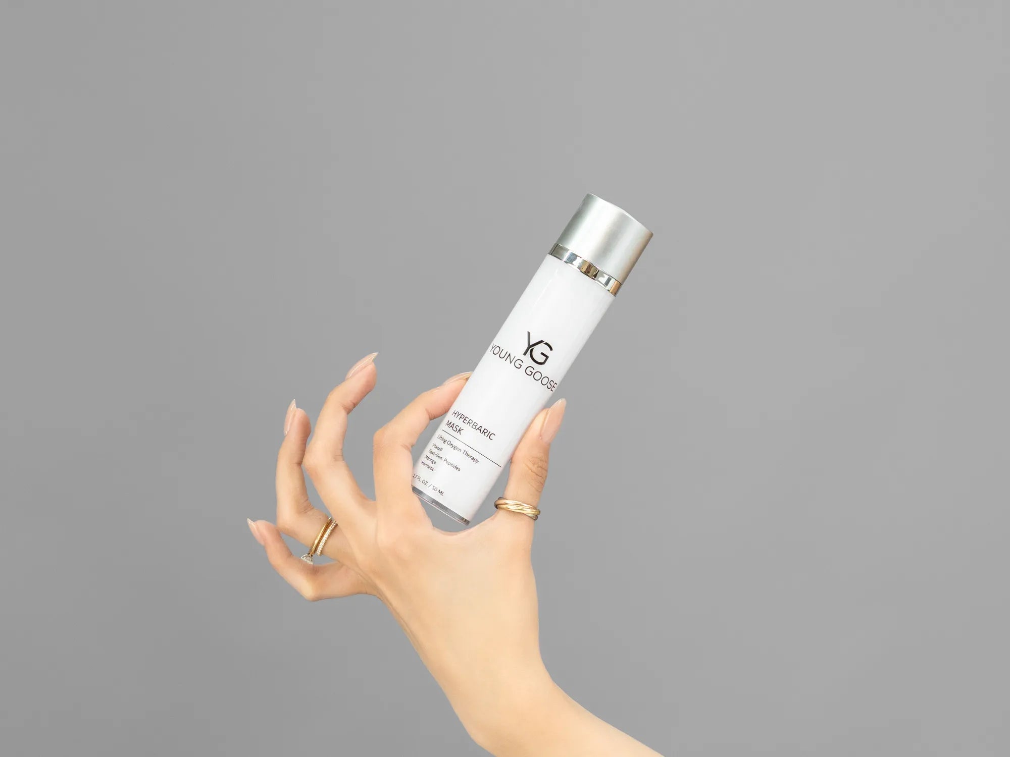 Closeup of Laziza from LAZ Skincare holding up a bottle of Young Goose Hyperbaric Mask