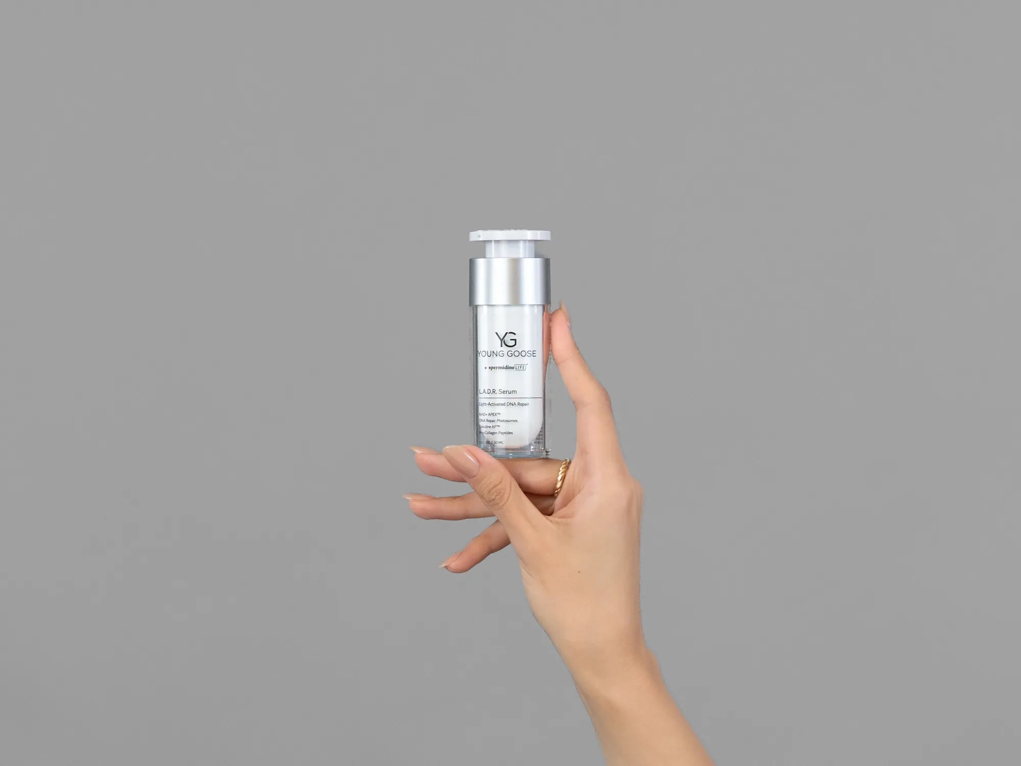 Closeup of Laziza from LAZ Skincare holding up a bottle of Young Goose L.A.D.R. Serum
