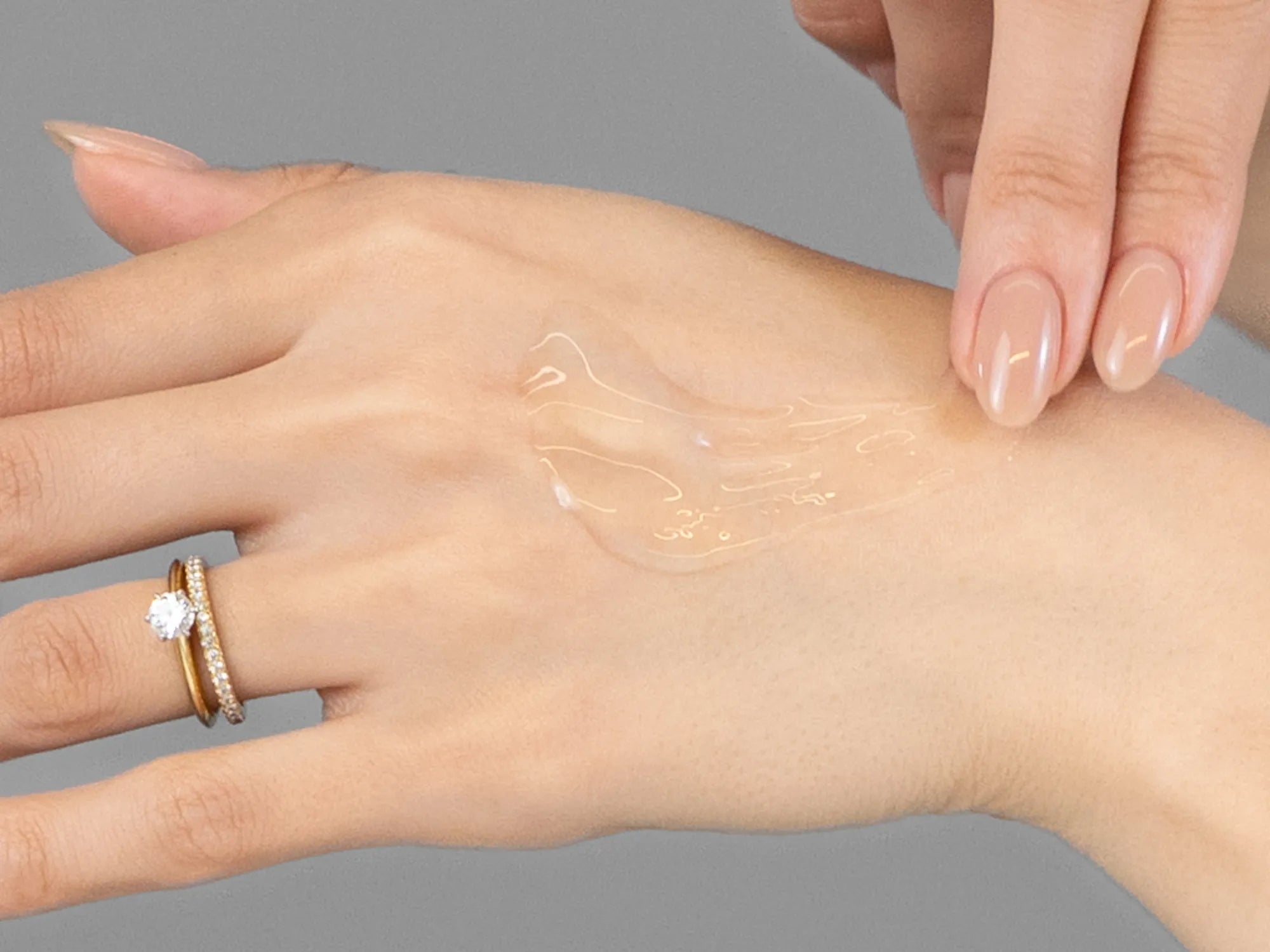 Laziza from LAZ Skincare demonstrating the texture and application of Young Goose Vampire Exosomes on her hand