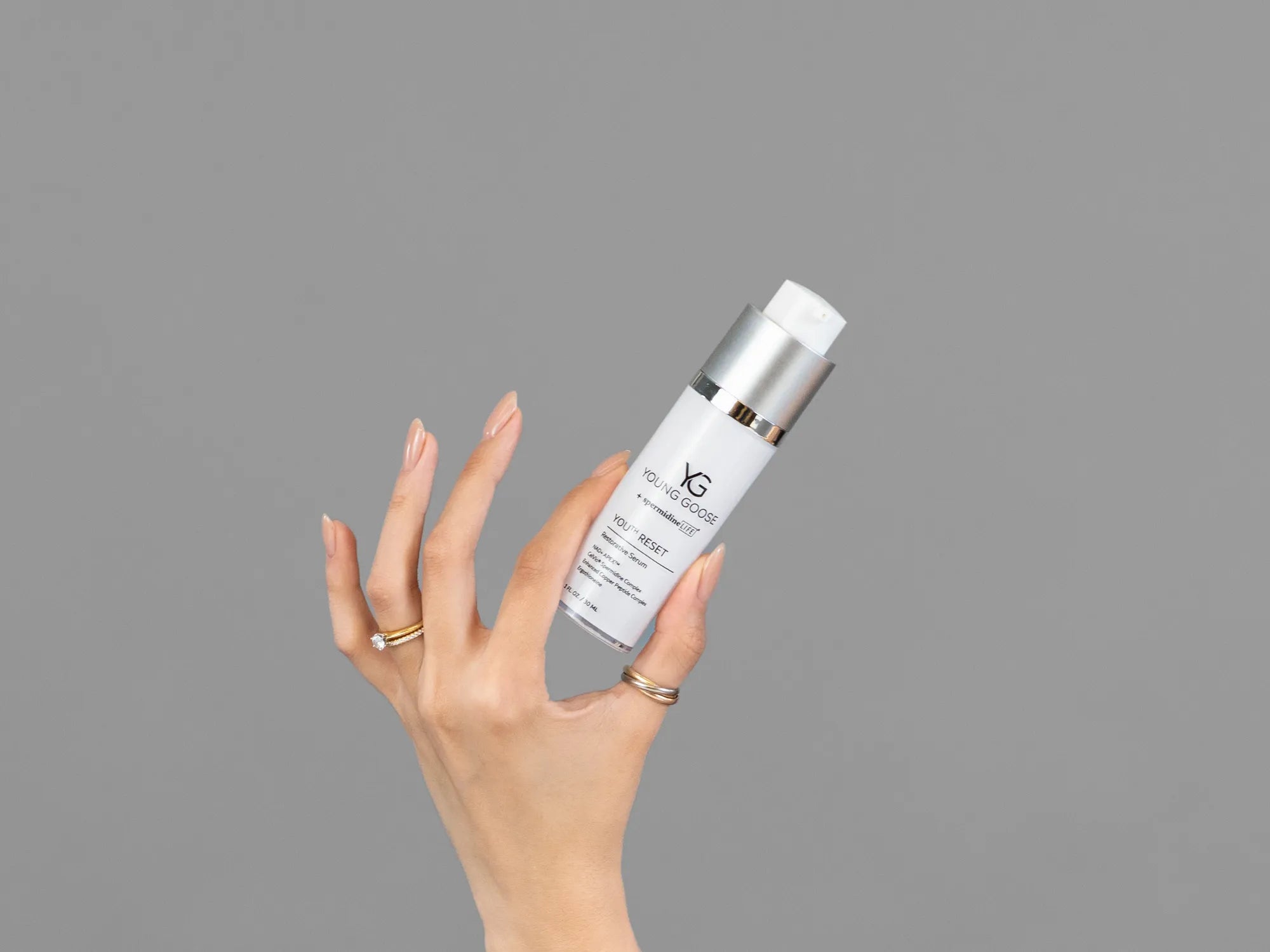 Closeup of Laziza from LAZ Skincare holding up a bottle of Young Goose Youth Reset